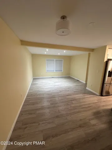 a view of an empty room and wooden floor