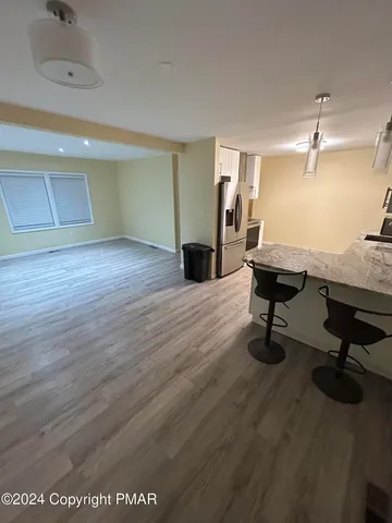 a view of a workspace with wooden floor