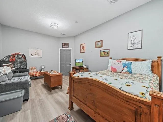 a bedroom that has a bed and a couch