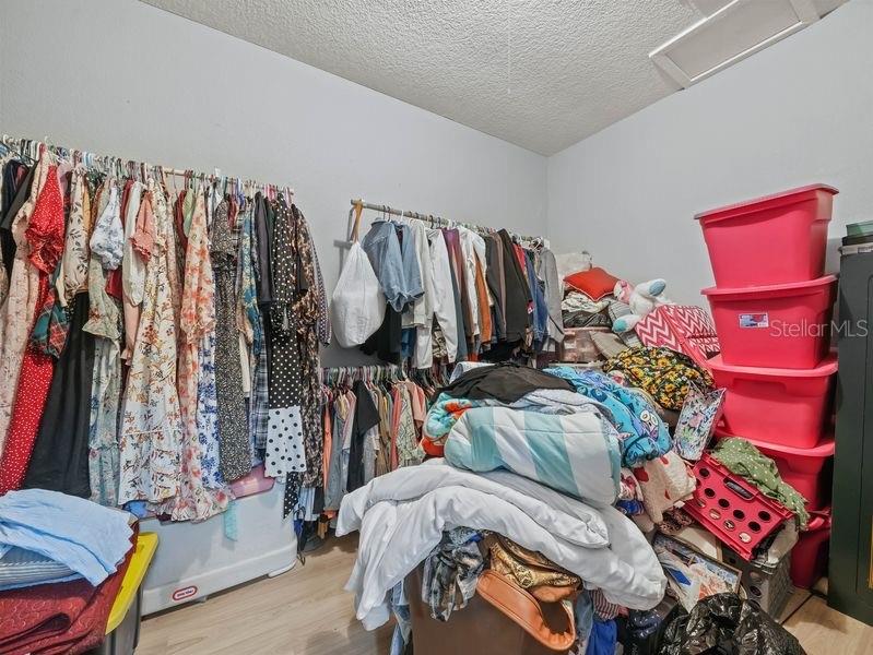 4485 Murphy Road Ona, FL 33865 - Photo 16 of 41 a view of walk in closet with clothes and shoes
