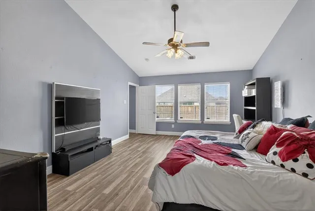 a bedroom with a bed and a flat screen tv