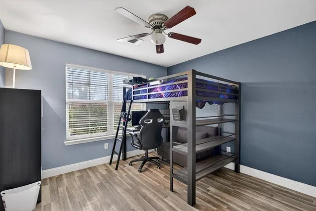 a view of a livingroom with furniture and a ceiling fan