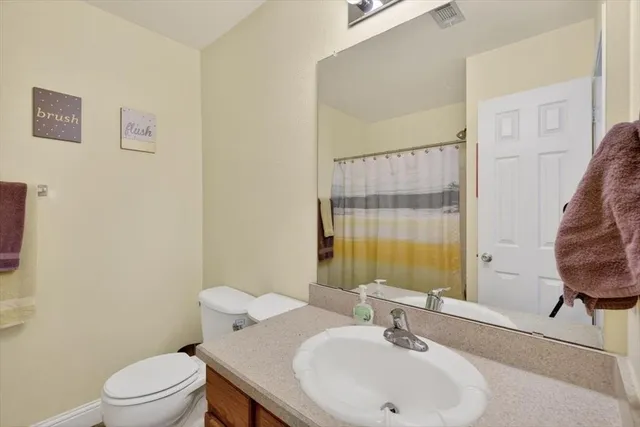 a bathroom with a sink toilet and mirror