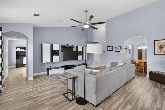 a living room with furniture and a wooden floor