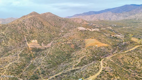 a view of a large mountain with mountains in the background