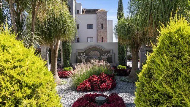 a front view of a house with a yard and a garden