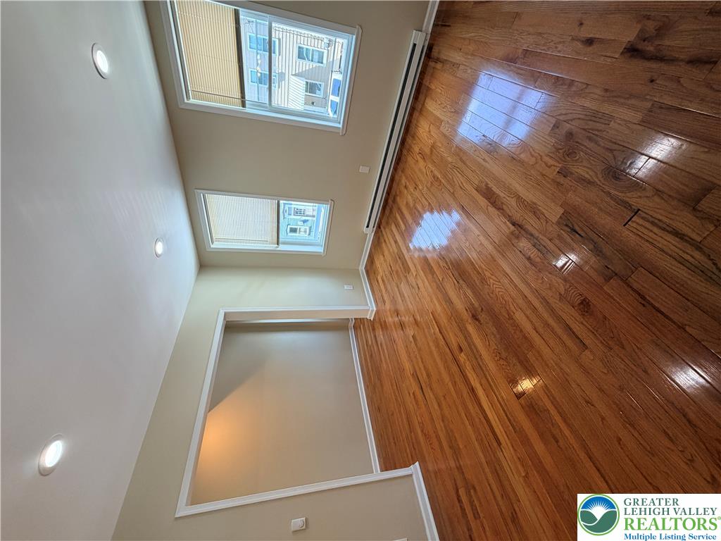 718 Ferry Street Easton, PA 18042 - Photo 2 of 37 Refined wood flooring extends across this room, complemented by ample natural illumination.