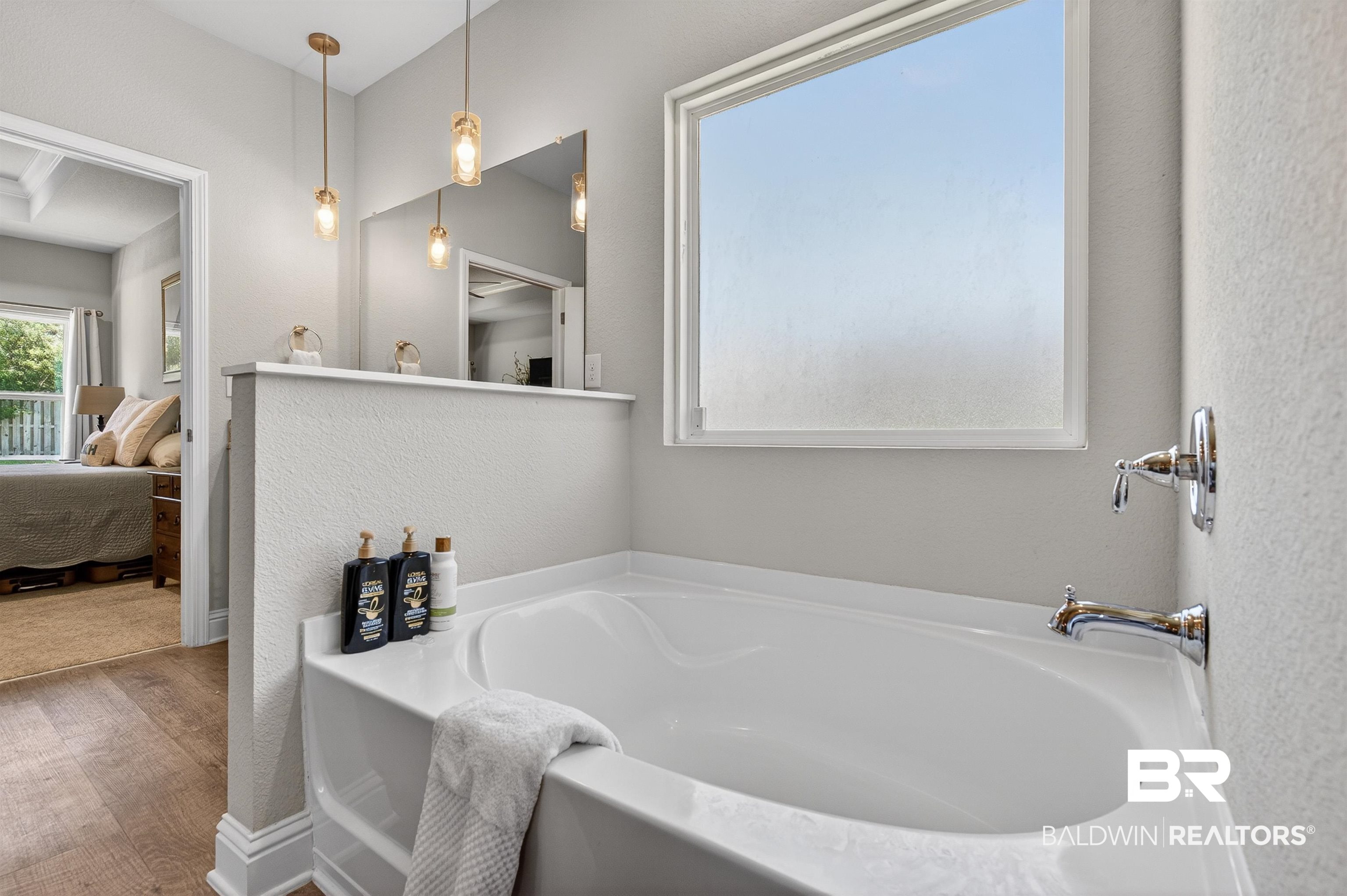 8735 Bronze Lane Foley, AL 36535 - Photo 27 of 58 Integrated soaking tub with chrome fixtures, frosted window, and two pendant light fixtures