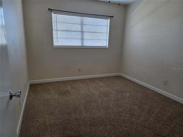 an empty room with a empty space and a window