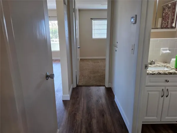 a bathroom with a granite countertop toilet and a sink