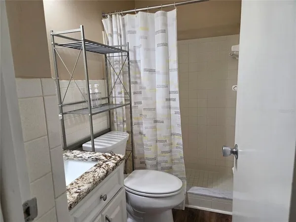 a view of empty room with ceiling fan