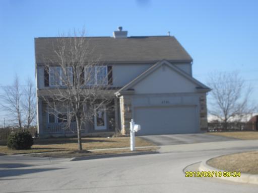 1721 Montclair Court Elgin, IL 60123 - Photo 1 of 11 a house that has a tree in front of it