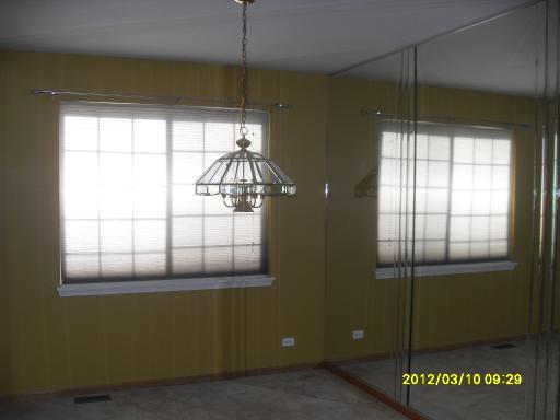 1721 Montclair Court Elgin, IL 60123 - Photo 6 of 11 a room with window and chandelier