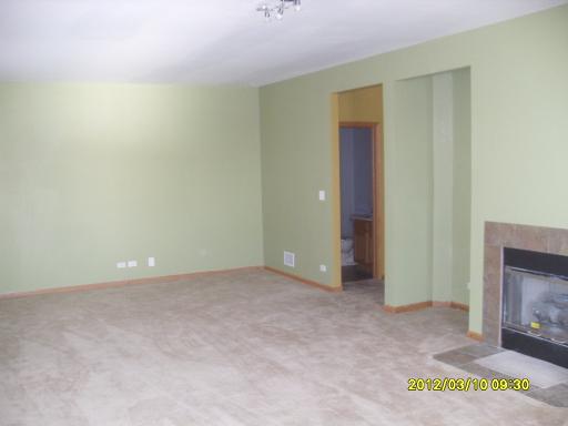 1721 Montclair Court Elgin, IL 60123 - Photo 7 of 11 a view of an empty room with a fireplace