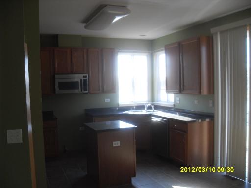 1721 Montclair Court Elgin, IL 60123 - Photo 8 of 11 a kitchen with a sink cabinets and window