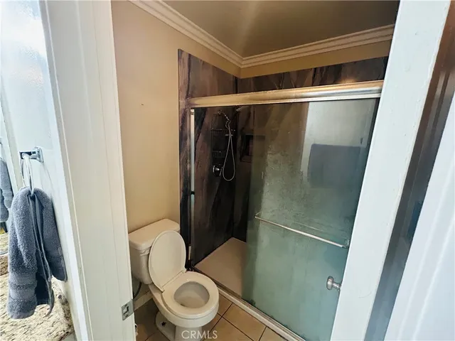a bathroom with a toilet and a shower