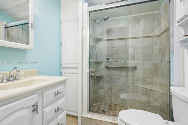 a bathroom with a sink toilet and shower