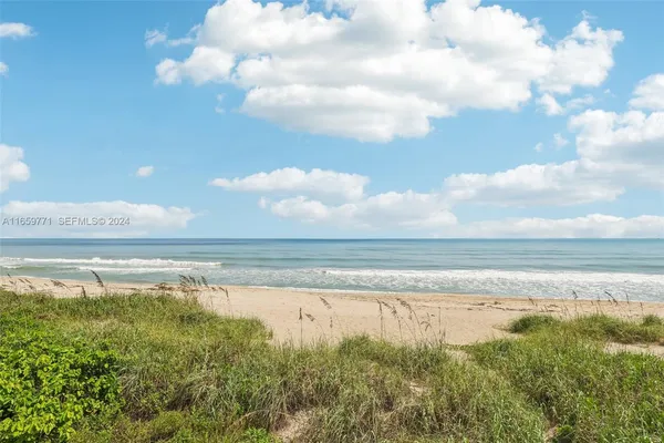 a view of a terrace with a bench and trees around