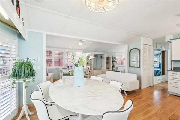 a living room with furniture a dining table and wooden floor