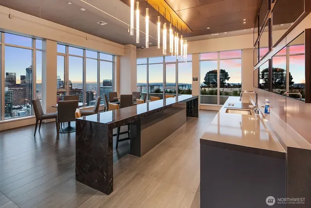 a dining hall with couches a coffee table and chairs with wooden floor