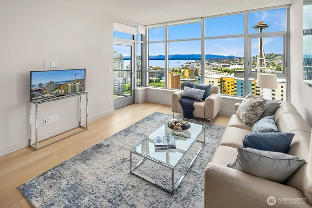 a living room with furniture and a floor to ceiling window