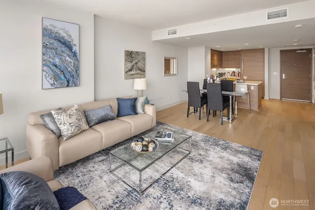 a living room with furniture and a dining table with kitchen view