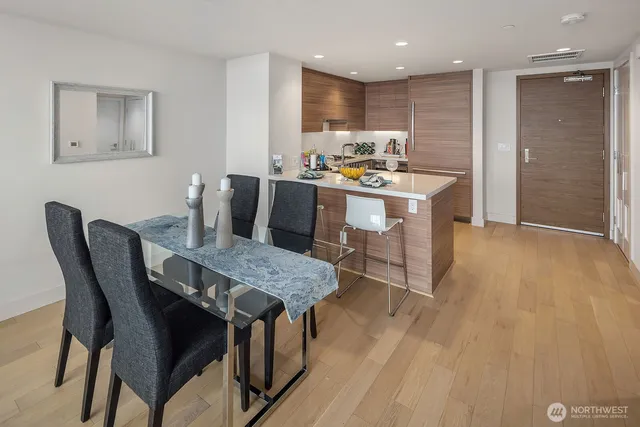 a dining room with furniture and wooden floor