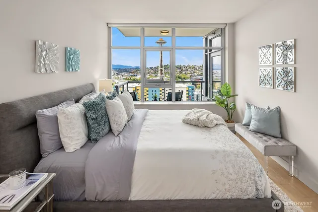 a bedroom with furniture and a large window