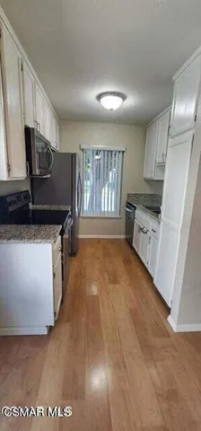 a kitchen with granite countertop a stove and a sink