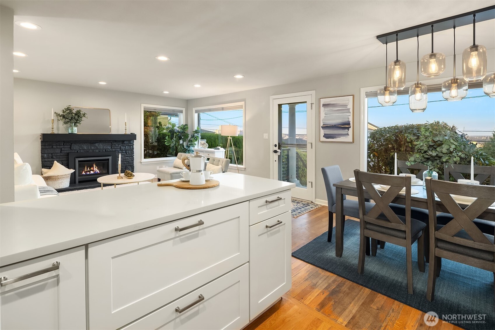 3257 37th Avenue Southwest Seattle, WA 98126 - Photo 12 of 40 a kitchen with a table chairs and white cabinets