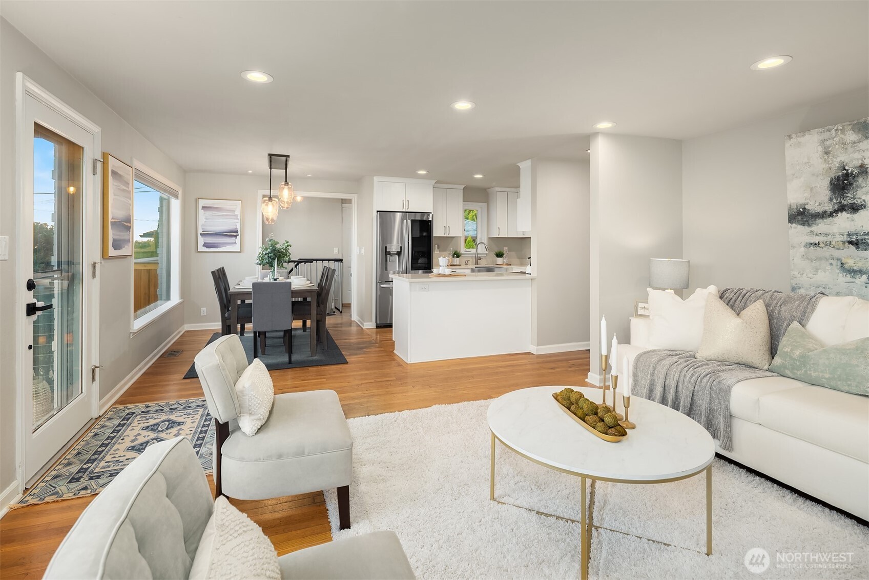 3257 37th Avenue Southwest Seattle, WA 98126 - Photo 6 of 40 a living room with furniture kitchen view and a wooden floor