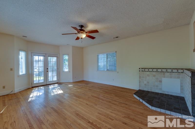 608 Cheney Street Reno, NV 89502 - Photo 11 of 22 a view of an empty room with a window and wooden floor