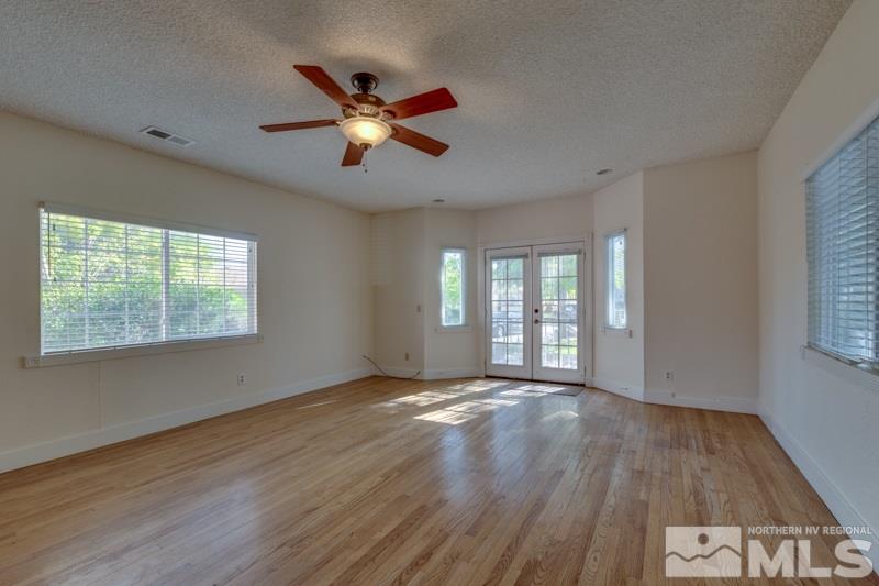 608 Cheney Street Reno, NV 89502 - Photo 12 of 22 a view of an empty room with wooden floor and a window