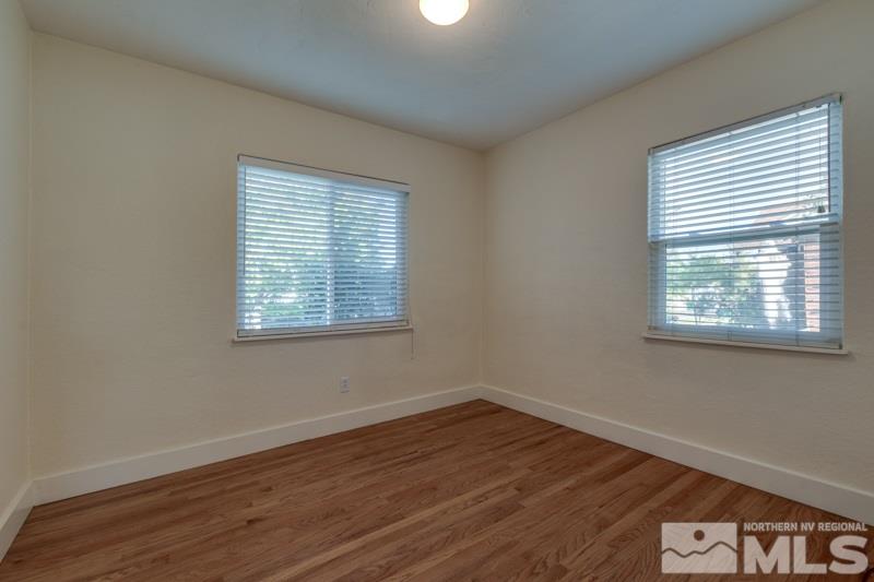 608 Cheney Street Reno, NV 89502 - Photo 13 of 22 a view of an empty room with wooden floor and a window