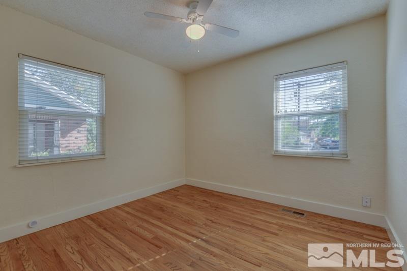 608 Cheney Street Reno, NV 89502 - Photo 14 of 22 a view of an empty room with wooden floor and a window