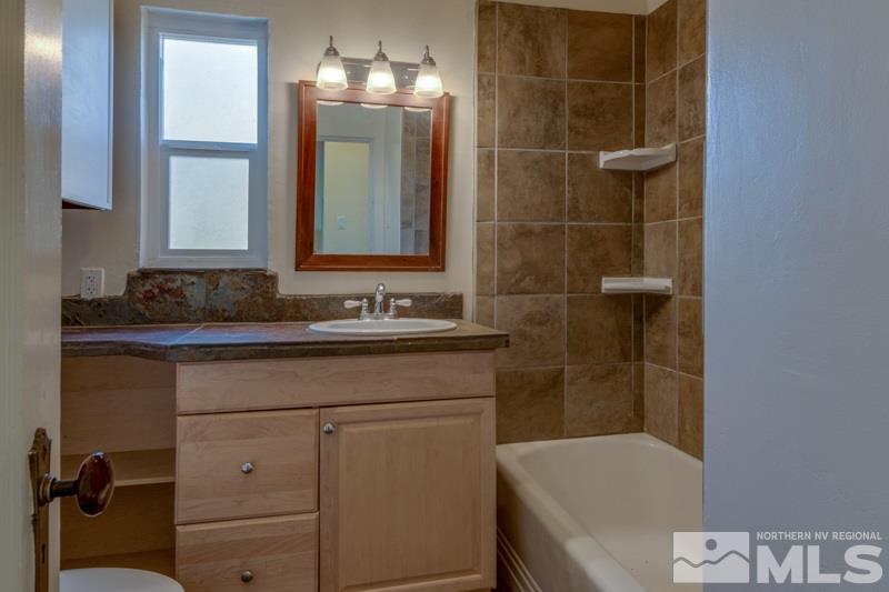 608 Cheney Street Reno, NV 89502 - Photo 15 of 22 a bathroom with a sink a toilet and shower