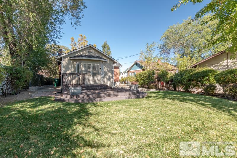 608 Cheney Street Reno, NV 89502 - Photo 21 of 22 a view of a house with a big yard potted plants and large tree