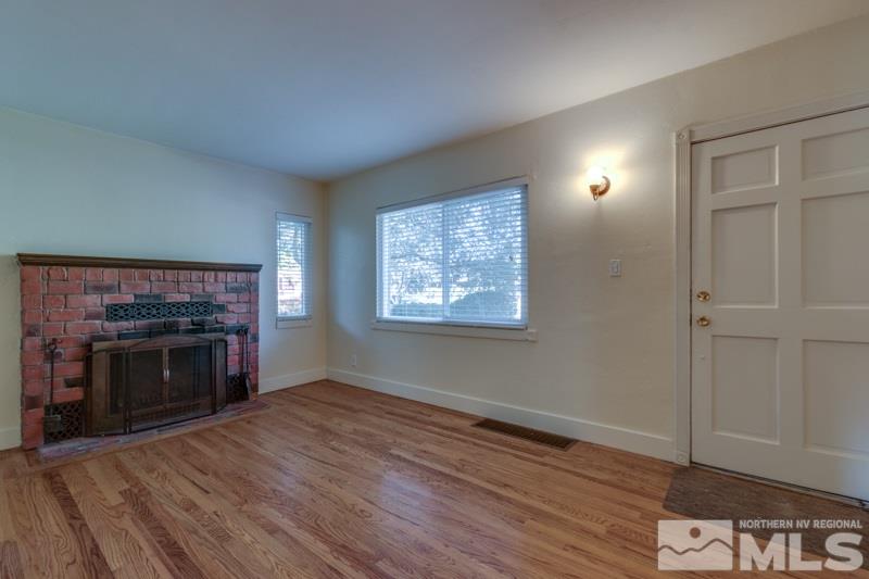 608 Cheney Street Reno, NV 89502 - Photo 5 of 22 wooden floor fireplace and windows in an empty room