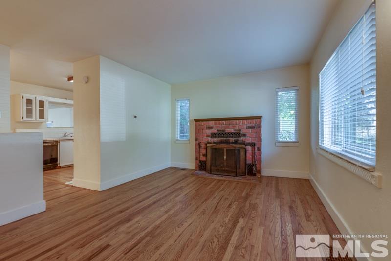 608 Cheney Street Reno, NV 89502 - Photo 6 of 22 a view of empty room with wooden floor and fireplace