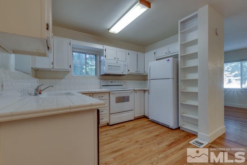 608 Cheney Street Reno, NV 89502 - Photo 8 of 22 a kitchen with a refrigerator stove and sink