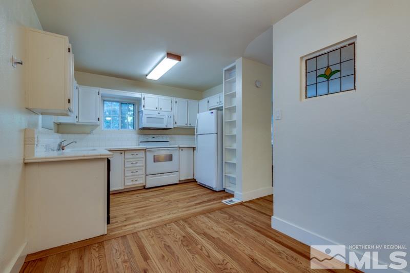 608 Cheney Street Reno, NV 89502 - Photo 9 of 22 a kitchen with stainless steel appliances granite countertop a refrigerator sink and cabinets