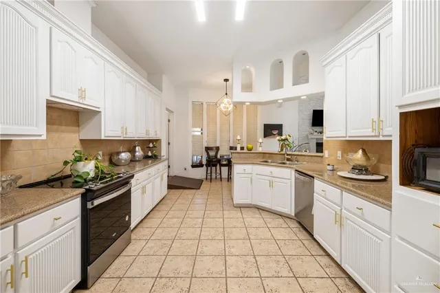 a white kitchen with stainless steel appliances