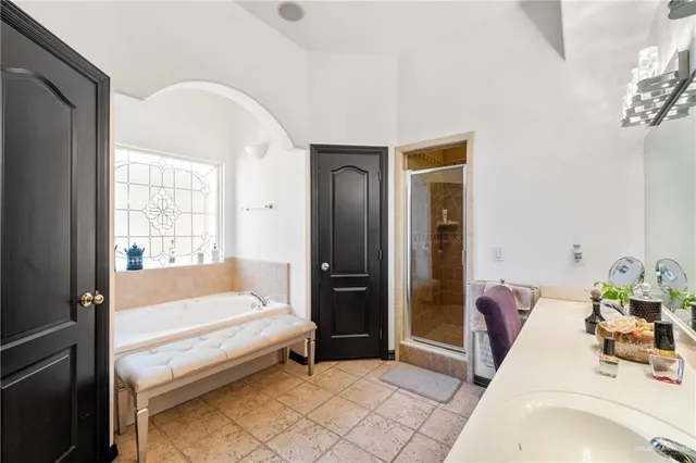 a spacious bedroom with a bed and a window