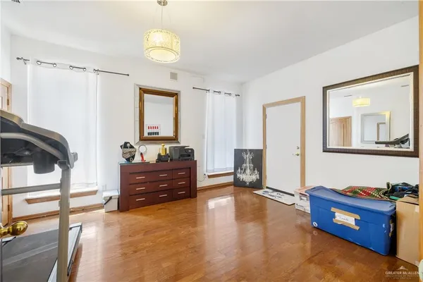a spacious bedroom with a bed and a dresser