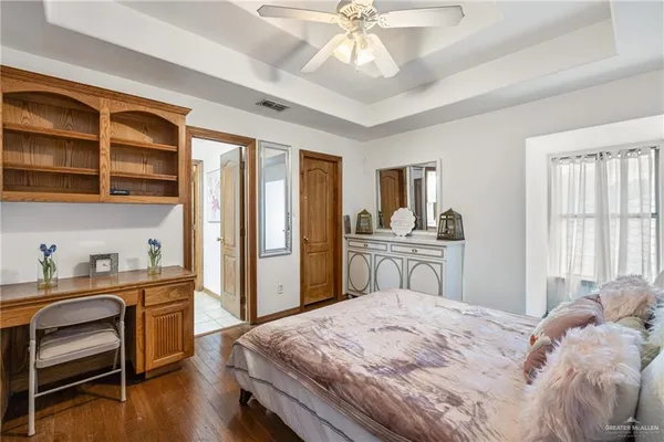 a bedroom with a bed and a desk