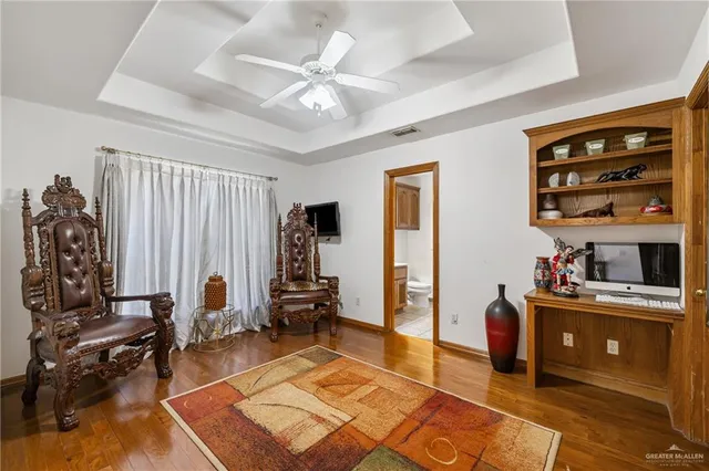 a living room with furniture a rug and gym equipment