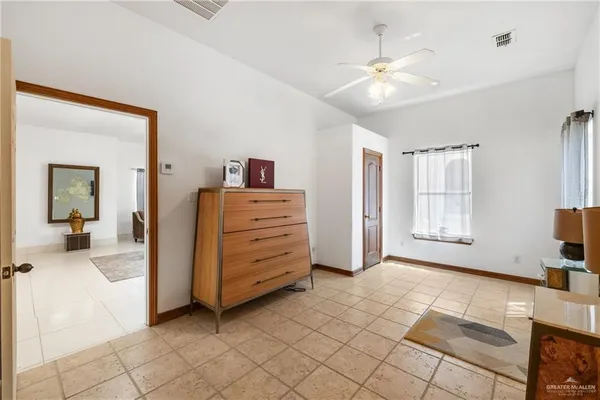 a view of a bedroom with furniture and natural light