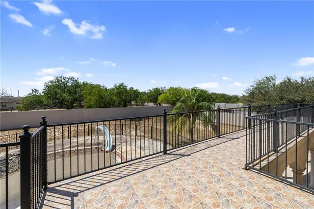 a balcony with trees in the background