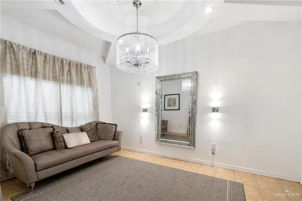 a living room with furniture and a chandelier