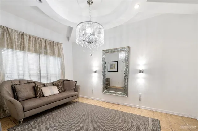 a living room with furniture and a chandelier